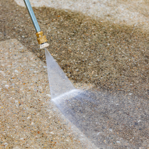 Will pressure washing remove oil stains from a driveway?